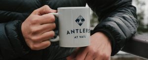 Antlers at Vail branding shown on coffee mug